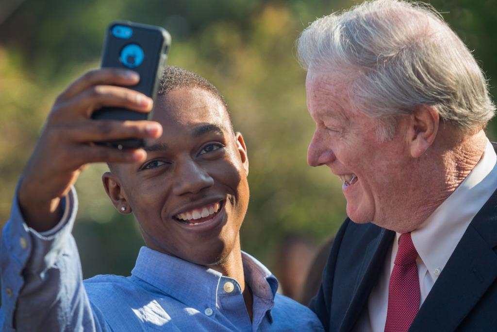 President Thrasher takes a selfie with a student Oct. 30, 2015, at Westcott Plaza. (FSU Photography Services)