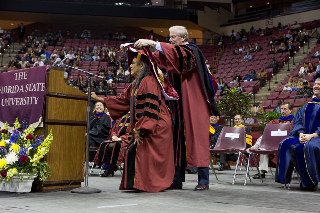 President Thrasher confers an Honorary Doctor of Humane Letters degree on Louise Gopher, a noted champion of education and a member of the Seminole Tribe of Florida, during Fall 2014 commencement Dec. 13, 2014, at the Donald L. Tucker Civic Center. (FSU Photography Services)