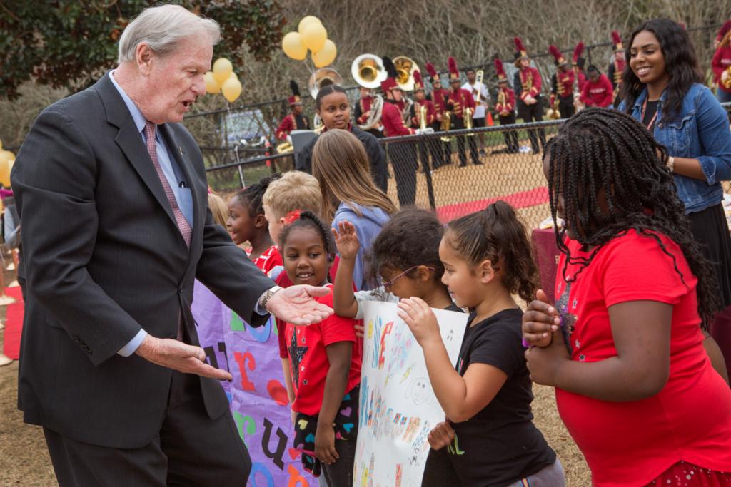 FSUS Executive Director Stacy Chambers and President John Thrasher with parents and students of the Florida State University School at the new playground's ribbon-cutting Feb. 14, 2018. (FSU Photography Services)