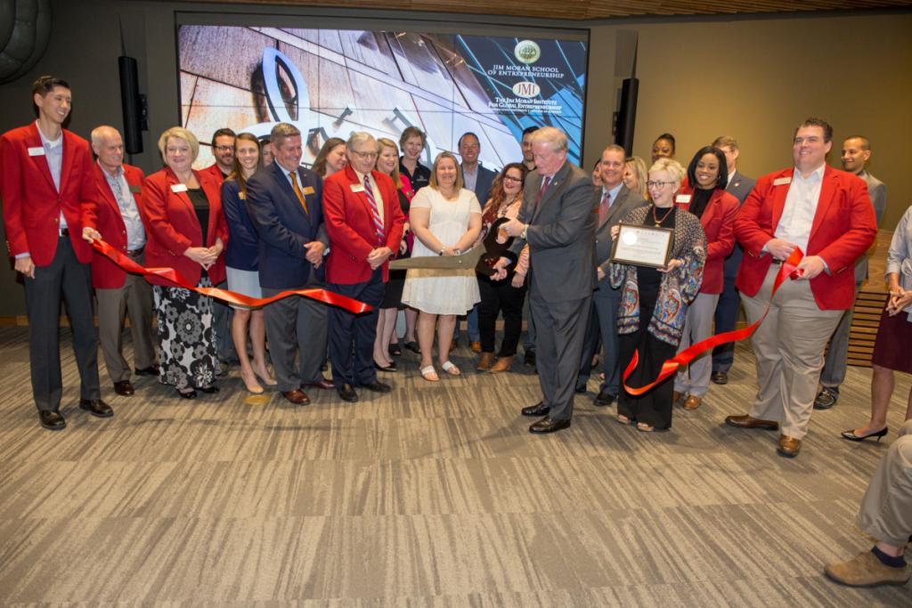 President John Thrasher cuts the ribbon along with members of the Greater Tallahassee Chamber of Commerce on Florida State University’s new entrepreneurship-focused Jim Moran Building May 18, 2018. (FSU Photography Services)