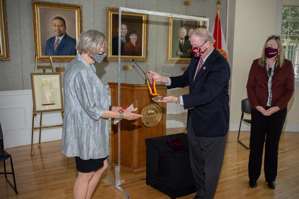 President John Thrasher bestows Patsy Palmer with the Westcott Medal in honor of her late husband President Emeritus Talbot “Sandy” D'Alemberte during a Sept. 22, 2020, ceremony at the College of Law. (FSU Photography Services)